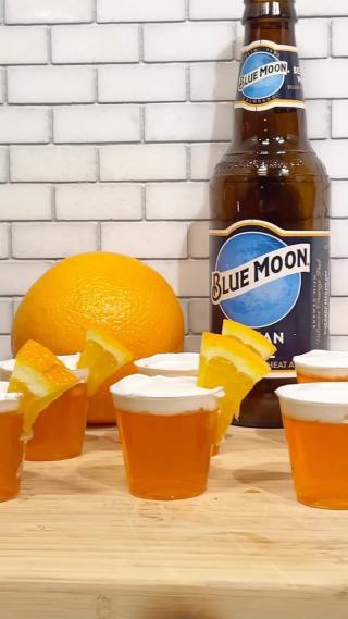 Big party coming up? Serve up this mini treat. 

INGREDIENTS:
2 3-oz. packages orange gelatin
2 c. boiling water
1 c. Blue Moon beer
1 c. vodka
1 c. cool whip
1 Orange, cut into tiny slices

STEPS:
1) In a large glass bowl, empty gelatin powder. Pour over boiling water & whisk until powder is completely dissolved.
2) Stir in Blue Moon & vodka.
3) Pour into plastic shot cups and refrigerate 2-3 hours, or until firm.
4) Top with whipped cream & garnish with a tiny orange slice.
5) Enjoy!